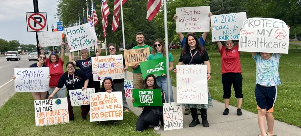 picketing group holding signs